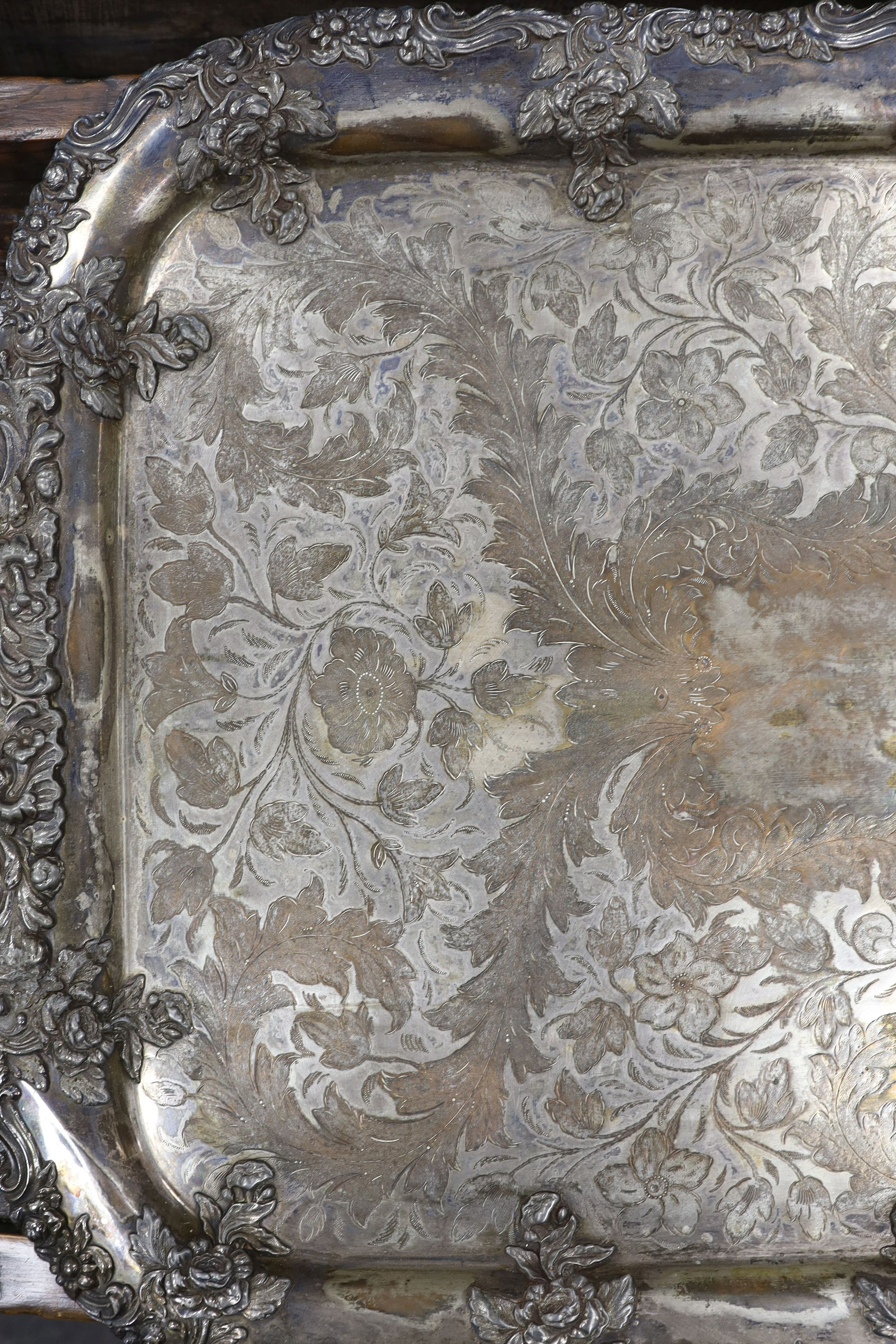 A large two handled silver plated tray with ornate floral edge, 87 cms wide.